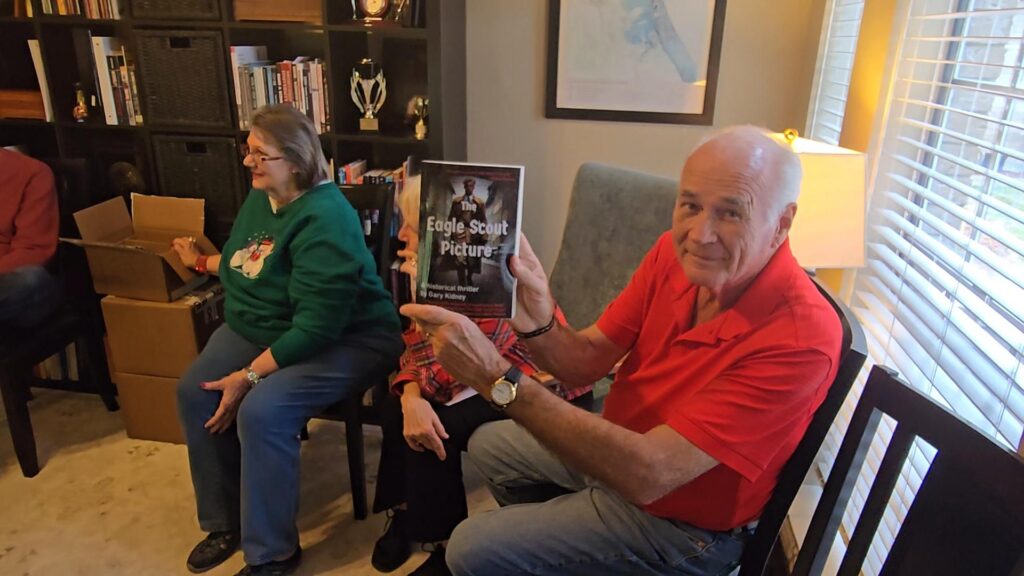 John Tullis, an early reader of the gripping WWII historical spy drama, displays the cover of The Eagle Scout Picture.