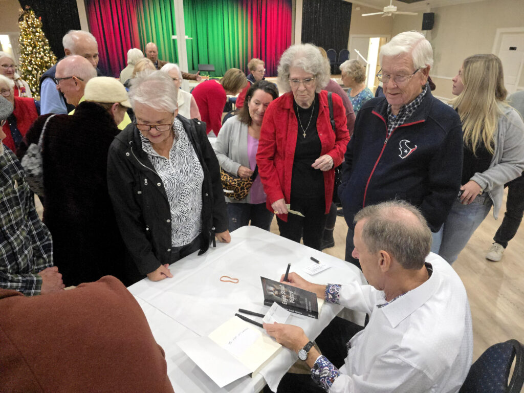 Gary Kidney autographing copies of The Eagle Scout Picture, a WWII historical spy drama and thriller